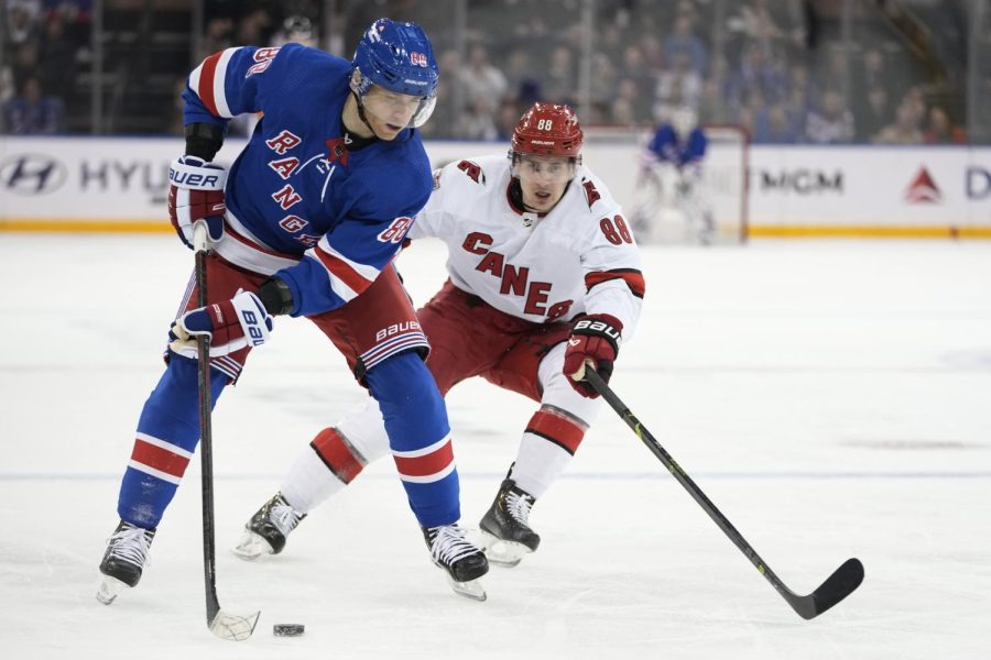 New York Rangers right wing Patrick Kane, left, is defended by Carolina Hurricanes center Martin Necas during the second period of an NHL hockey game Tuesday, March 21, 2023, at Madison Square Garden in New York. (AP Photo/Mary Altaffer)