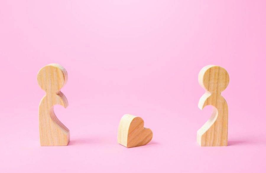 Two wooden figures with a heart shaped hole in between them. Columnist Nanette Nkolomoni expresses that friends growing apart is a natural process.