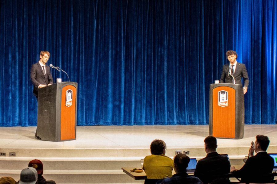 “Junior meteorology major and current Trustee Tim Moore (left) and junior pre-medical chemistry major Yazan Masri debate for the SGA representative seat on the NIU Board of Trustees Monday at the Carl Sandburg Auditorium. The canidates answered questions from the public before having the chance to question one another during the debate. (Nyla Owens | Northern Star)”