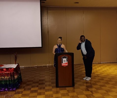 Trevon Smith (right), president of Prism and senior women, gender and sexuality major, being awarded the Howard and Mellie Eychaner Award by Molly Holmes (left), Director of the Gender and Sexuality Resource Center. (Caleb Johnson | Northern Star)