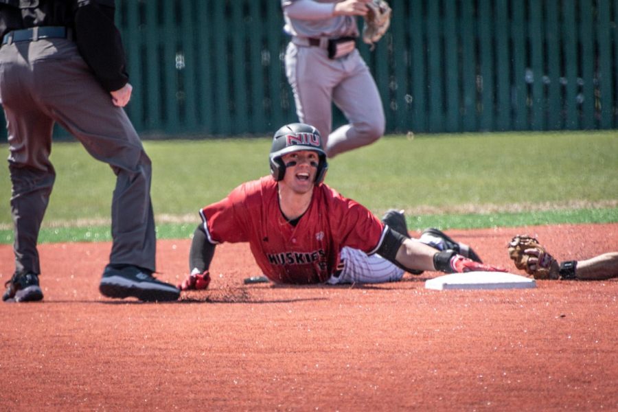 NIU then-junior first baseman Colin Summerhill (8) is declared safe after sliding into second base on a double in the bottom of the first inning on April 9, 2023. Summerhill blasted two home runs in a 13-5 loss against the University of Cincinnati on Friday. (Mingda Wu | Northern Star)