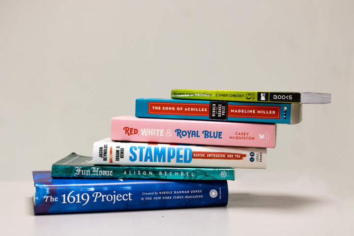 A stack of banned and LGBTQ+ themed books sit atop each other. Books such as these were discussed in a lecture about LGBTQ+ inclusion in curriculum. (Sean Reed | Northern Star)