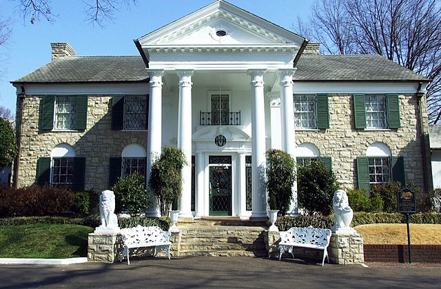 The exterior of Graceland has statues of lions and grand architecture