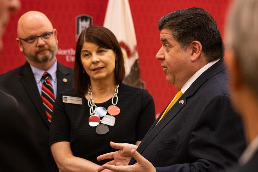 Illinois Representative Jeff Keicher (left), NIU President Lisa Freeman and Illinois Governor J.B. Pritzker in conversation after a press conference Tuesday. During this press conference, Pritzker spoke on college funding and ensuring affordable education for Illinois students. (Sean Reed | Northern Star)