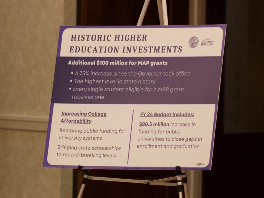 A poster describing investments in higher education including grants and information about the proposed Illinois budget for FY24. The poster highlights the increase in investment by the governor, including an additional $100 million for MAP grants. (Sean Reed | Northern Star)