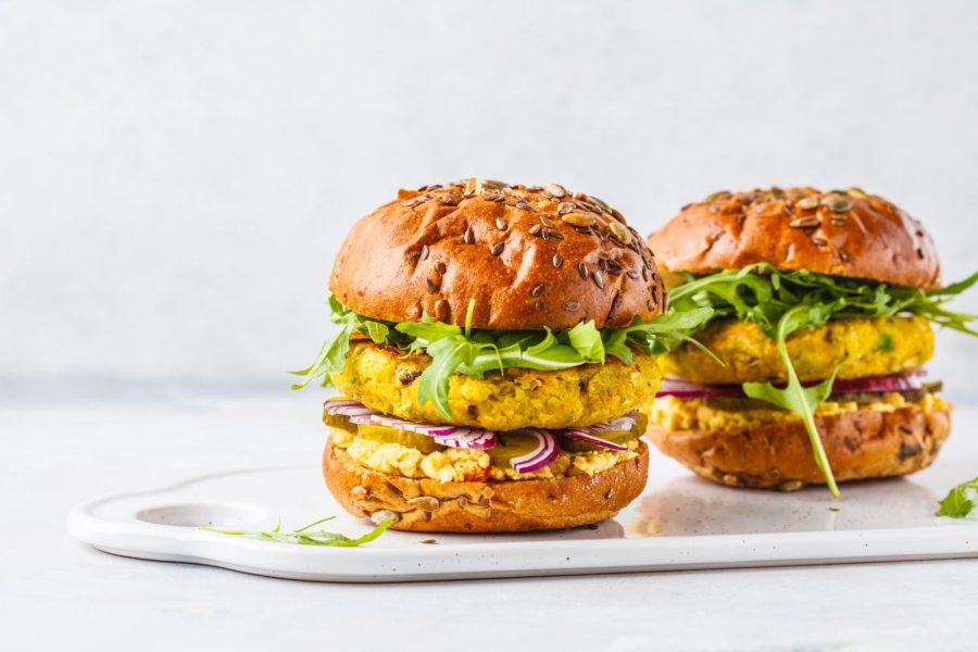 Two vegan chickpea burgers sitting on a platter. Columnist Lucy Atkinson suggests taking a chance on vegan options when eating at fast-food chains. 