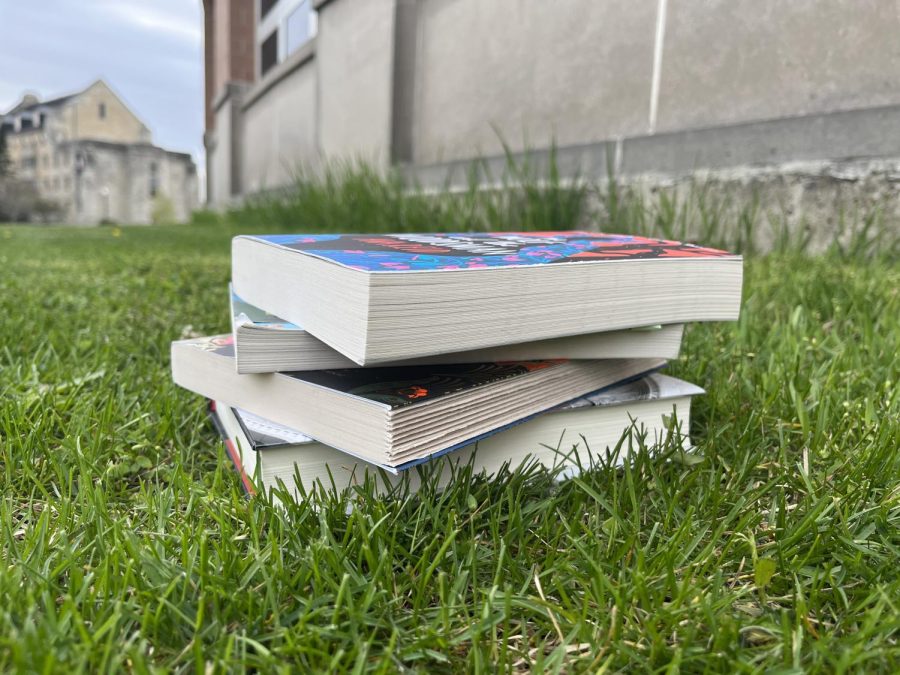 A stack of books sitting outside. As the spring season arrives, consider adding some books to your reading list. (Sarah Rose | Northern Star)