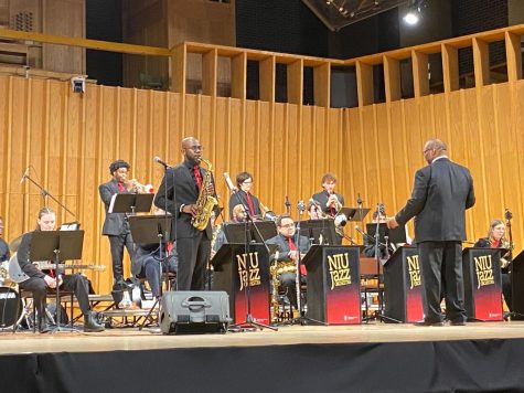 Director Reggie Thomas leads the NIU jazz orchestra. The orchestra performed Thursday at the Boutell Memorial Concert Hall. (Eli Tecktiel | Northern Star)