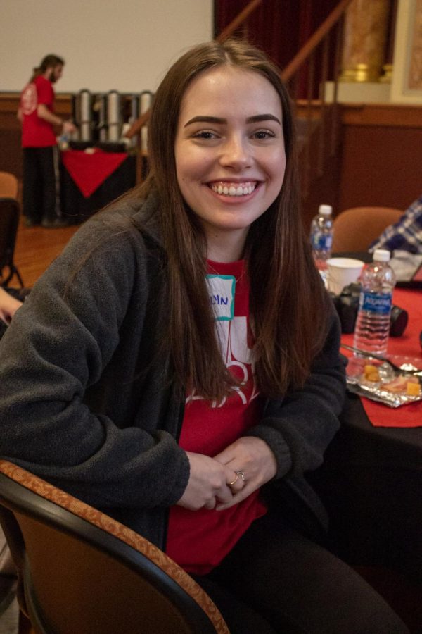 Madelyn Gluck, a junior medical lab science major, sitting at a table during breakfast in Altgeld Hall. Gluck said she volunteered because it sounded fun and would look good on her resume. This year, NIU Cares partnered with local businesses to send volunteers in order to help with a variety of projects. (Madelaine Vikse | Northern Star)