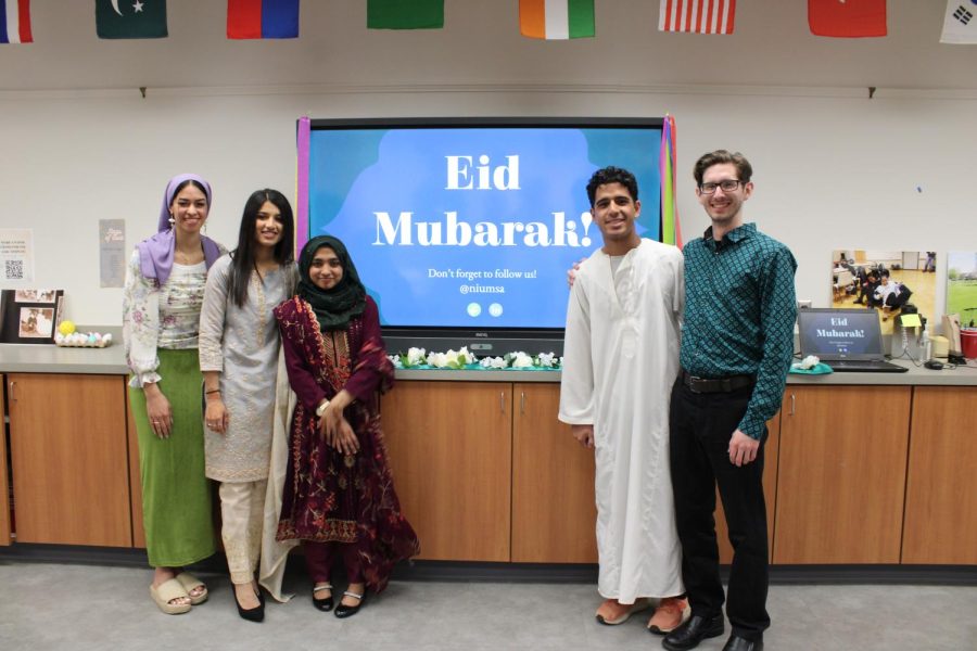 The board members of the Muslim Student Association standing in front of their presentation about Eid on Tuesday. The group put together an event discussing a Muslim tradition that falls after Ramadan called Eid, as a part of Asian Heritage month. (Nyla Owens| Northern Star)