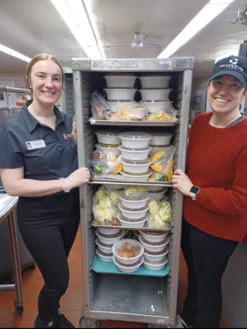 Stacia Tietje (left), a dietetic intern, and Nancy Prange, dietetic internship director, with packaged food collected by Huskie Harvest. Huskie Harvest was launched on Feb. 1 by Prange, in collaboration with Campus Dining Services. 