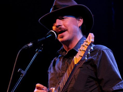 Jason Molina playing a guitar on stage as a part of Magnolia Electric Co. Ten years after his death, his music has taken on a new meaning among his fans. 