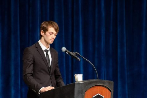 Junior meteorology major and Trustee Tim Moore stands at the podium during the trustee debate before the SGA elections Monday on stage the Carl Sandburg Auditorium. Prior to elections, Moore sent a mass-email titled “VOTE NOW TO PREVENT DECREASE IN ATHLETIC FUNDING,” encouraging students to vote for the NIUnited ticket, resulting in a reprimand for members of the ticket. (Nyla Owens | Northern Star)