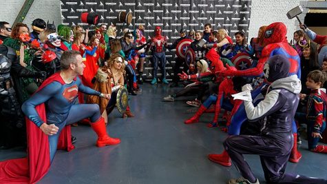  At a comic convention in Brussels, Belgium a group of people dressed in DC characters (left) and Marvel characters face each other symbolizing the great debate of Marvel vs. DC Comics. (Miguel Discart | Wikimedia commons)