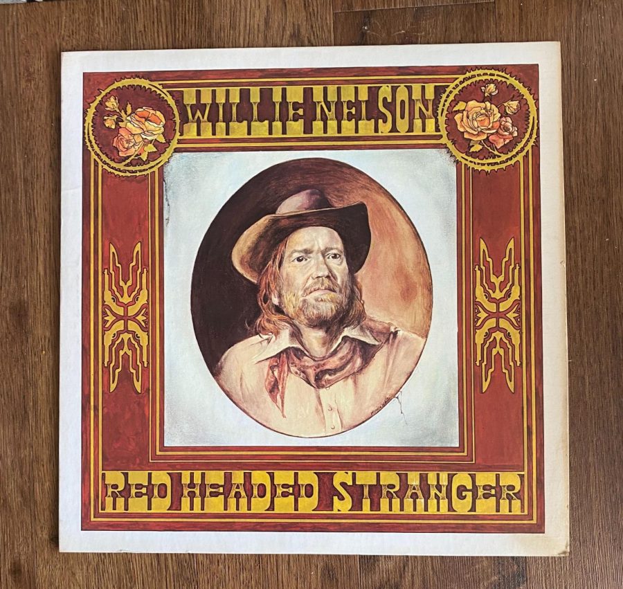 A+brown+and+yellow+vinyl+cover+of+Willie+Nelsons+album+Red+Headed+Stranger+lays+on+a+wooden+table.+In+honor+of+Nelson+turning+90%2C+check+out+the+album+and+his+new+single+Summertime.+%28Eli+Tecktiel+%7C+Northern+Star%29