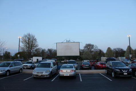 Cars lined up in Parking Lot E by Anderson Hall facing  a projector screen to watch “Top Gun: Maverick.” The drive-in movie night was hosted by the Campus Activity Board. (Nyla Owens | Northern Star)