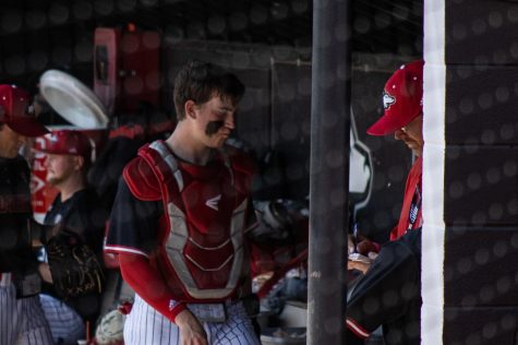 Junior catcher Colin Summerhill (left) approaches NIU Baseball Head Coach Mike Kunigonis in the dugout during the teams game against Toledo Sunday at Ralph McKinzie Field. The game was Kunigonis last as a head coach at NIU, after his contract was not renewed and he was relieved from his position. (Sean Reed | Northern Star)