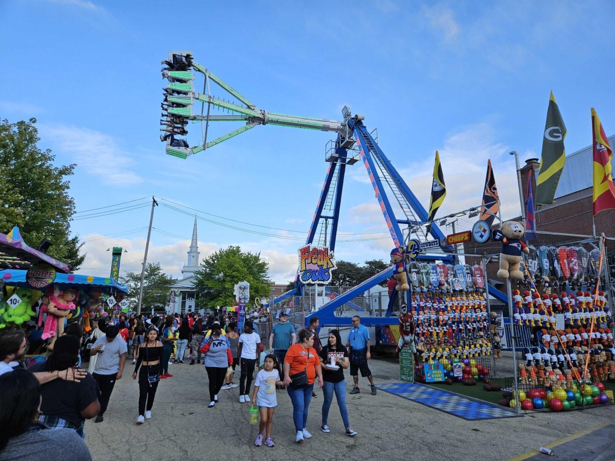 Corn Fest attendees enjoy rides and carnival games on Saturday at the 46th annual Corn Fest in downtown DeKalb on 1st and 4th Street. The festival took place from Aug. 25 to Aug. 27 and expects up to 15,000 festival-goers every year. (Joseph Howerton | Northern Star)