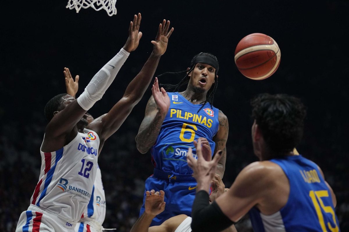 Philippines guard Jordan Clarkson (6) passes the ball to teammate June Mar Fajardo (15) during the Basketball World Cup at the Philippine Arena in Bulacan province, Philippines Friday, Aug. 25, 2023. (AP Photo)