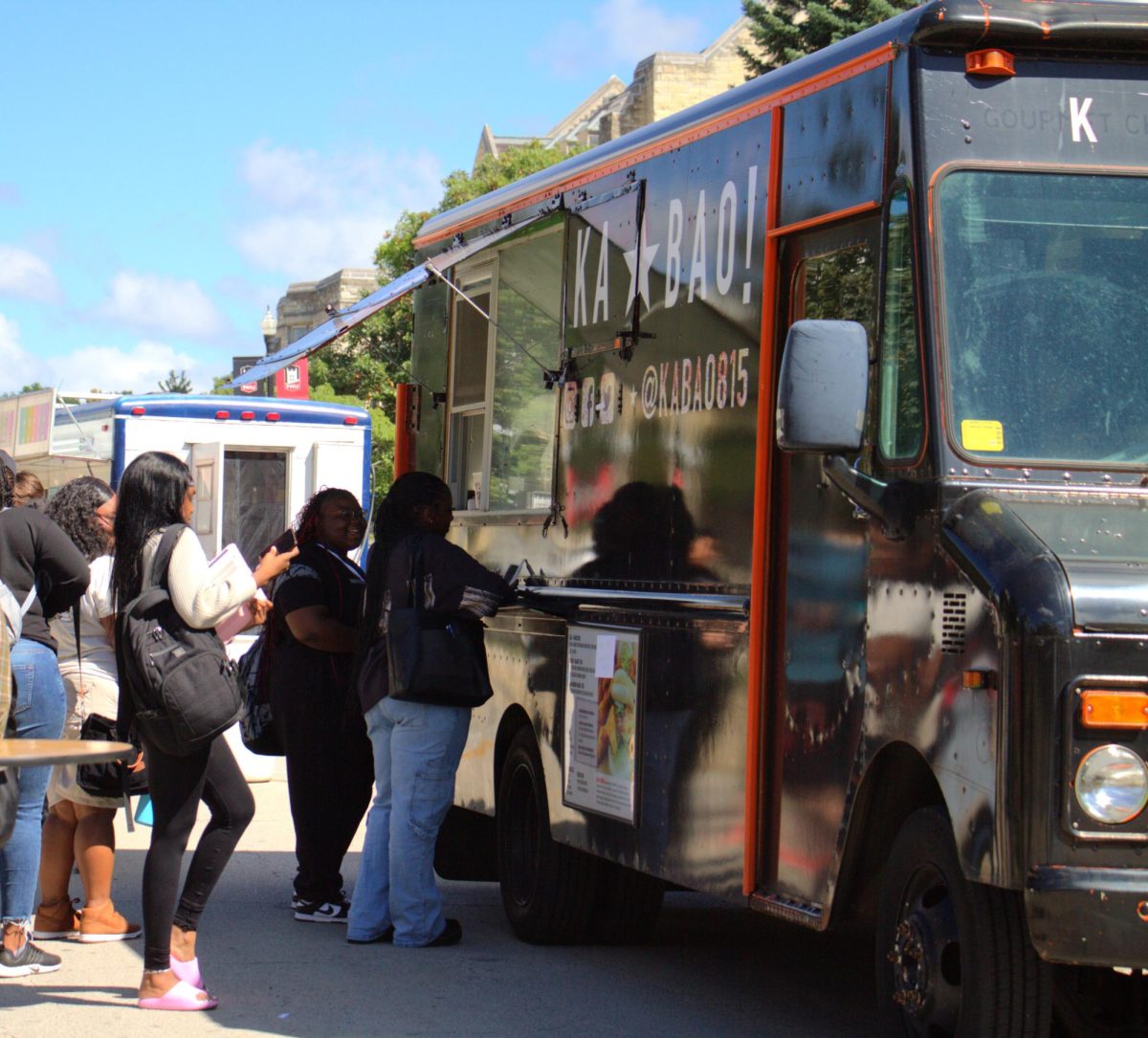 Students line up on Normal Road to order food after long classes on a Wednesday morning. This Wednesday is the last day of food trucks for the Fall 2023. (Ariyonna Mcgahee | Northern Star)