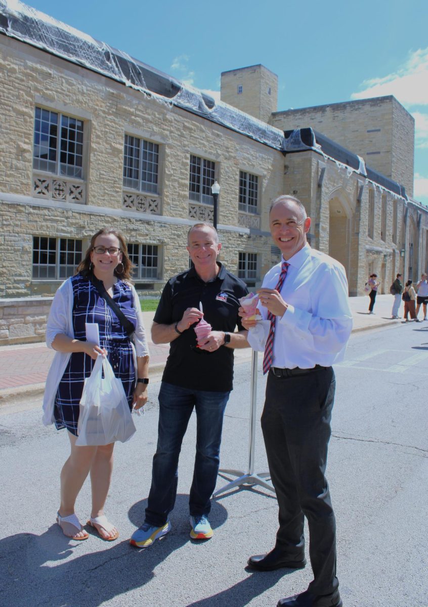 Liz Wright (left), the executive assistant to the president, Matt Streb, the chief strategy officer and George Middlemist, vice president for administration and finance, trying out KA-BAO and Little Os frozen treats food trucks on Wednesday. Food Truck Wednesdays will be happening 11 a.m. to 2 p.m. every Wednesday on Normal Road until the end of September. (Nyla Owens | Northern Star)
