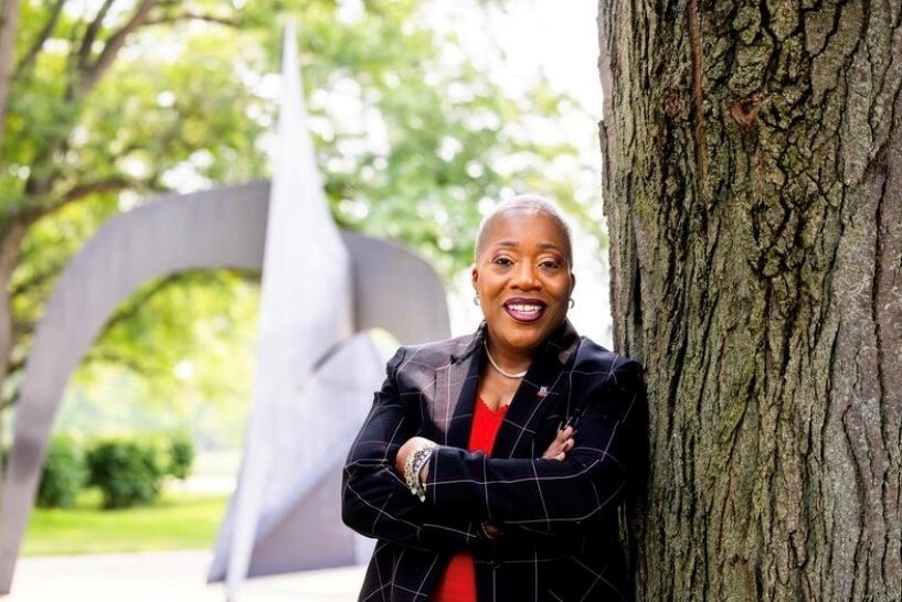 Carol Sumner, vice president of Diversity, Equity and Inclusion leans on a tree outside. Sumner was hired in the summer, and explained her plans for DEI at NIU. (Courtesy of Carol Sumner)