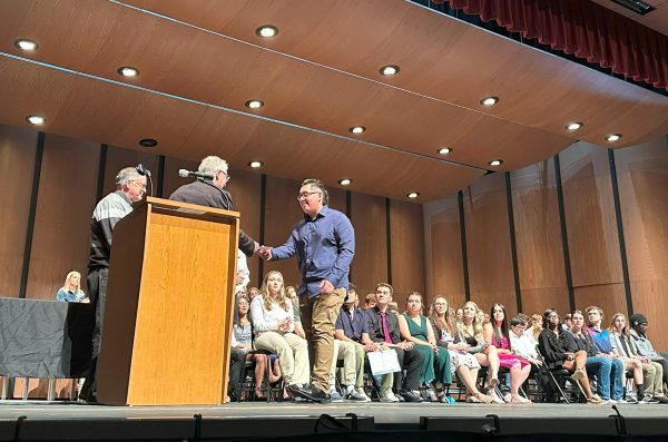 A DeKalb High School student walks across stage to receive the DHS Alumni Scholarship award. This DeKalb student, along with 136 others in the county, earned scholarships from the DeKalb County Community Foundation. (Courtesy of the DeKalb County Community Foundation)