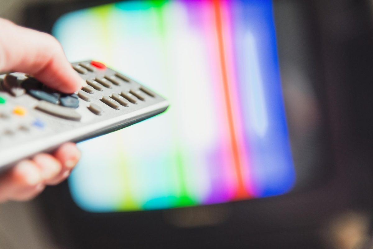 A TV remote points toward a screen. Lifestyle Writer Caleb Johnson recommended three movies and a show to watch. (Courtesy of Getty Images)