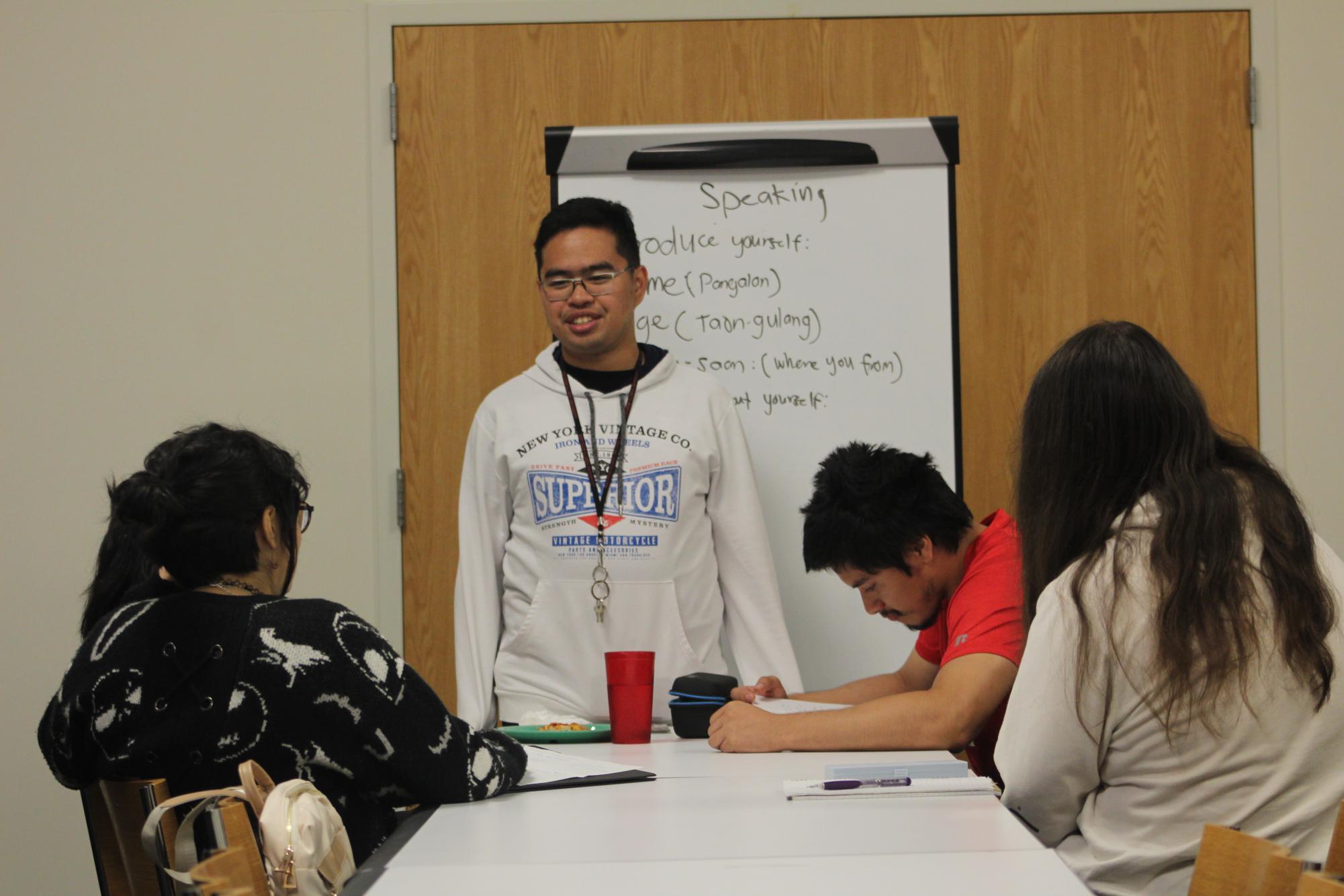 Isiah Camarao, a sophomore biological sciences major, teaches a group at the Foreign Language Residence Program to speak Tagalog. The Foreign Language Residence Program helps to teach language through conversation. (Michael Mollsen | Northern Star)