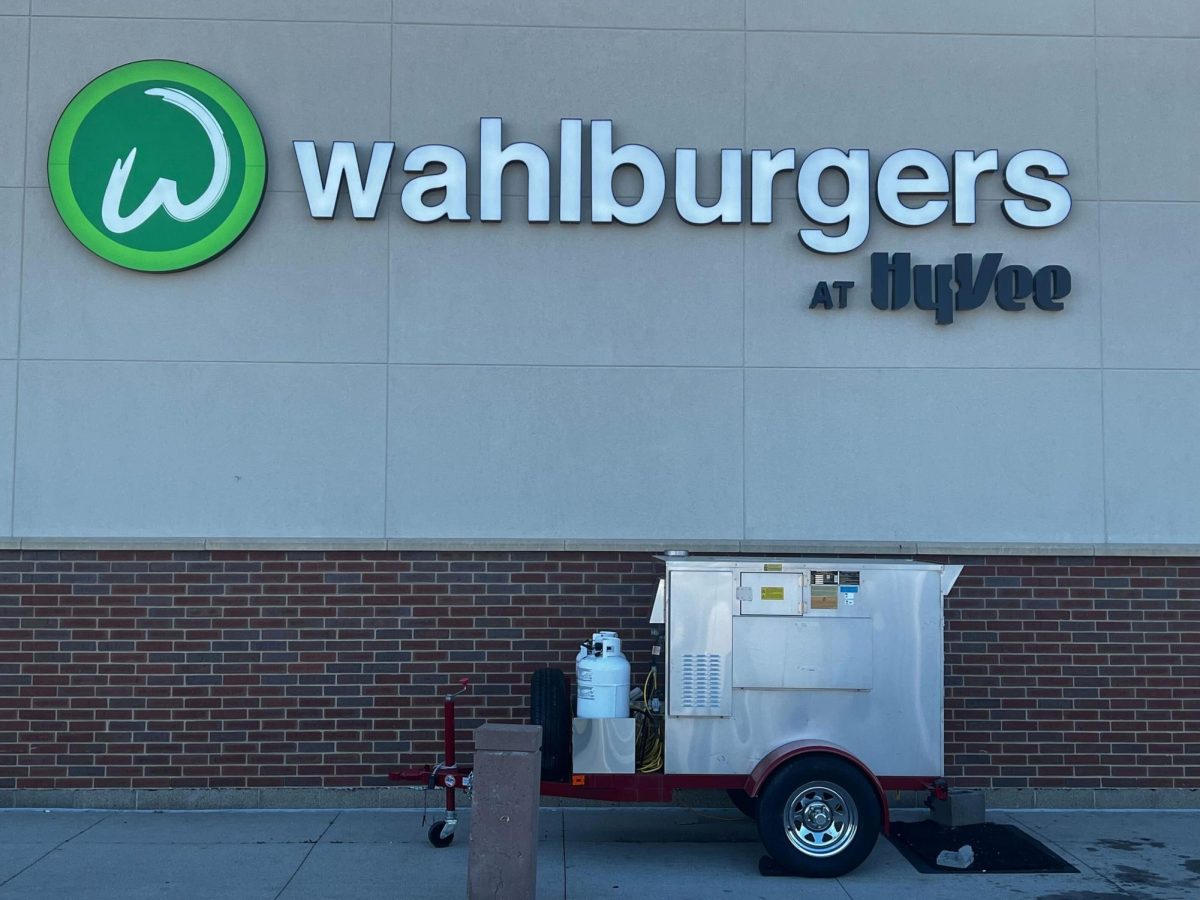 The new Wahlburgers restaurant sign advertised on the Hy-Vee grocery store. (Brandon Clark | Northern Star)