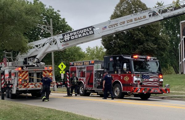 Firefighters from the DeKalb Fire Department take out tools from their fire engines with the sign “#ProudlyDeKalb” displayed on the engine’s ladder. A fourth fire station is expected for the City of DeKalb. (Rachel Cormier | Northern Star)