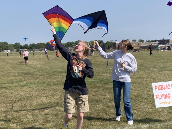Two girls run to get their kites in the air on Sunday at DeKalb Kite Fest. The DeKalb Park District held its 18th annual DeKalb Kite Fest at Kiwanis Park. (Rachel Cormier | Northern Star)