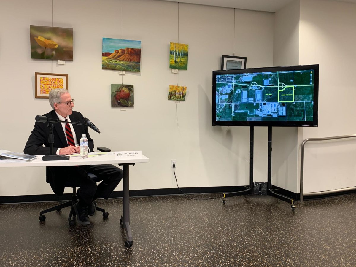 City Manager Bill Nicklas explains the location of the projected warehouses in relation to Peace Road and neighboring warehouse properties. (Rachel Cormier | Northern Star)