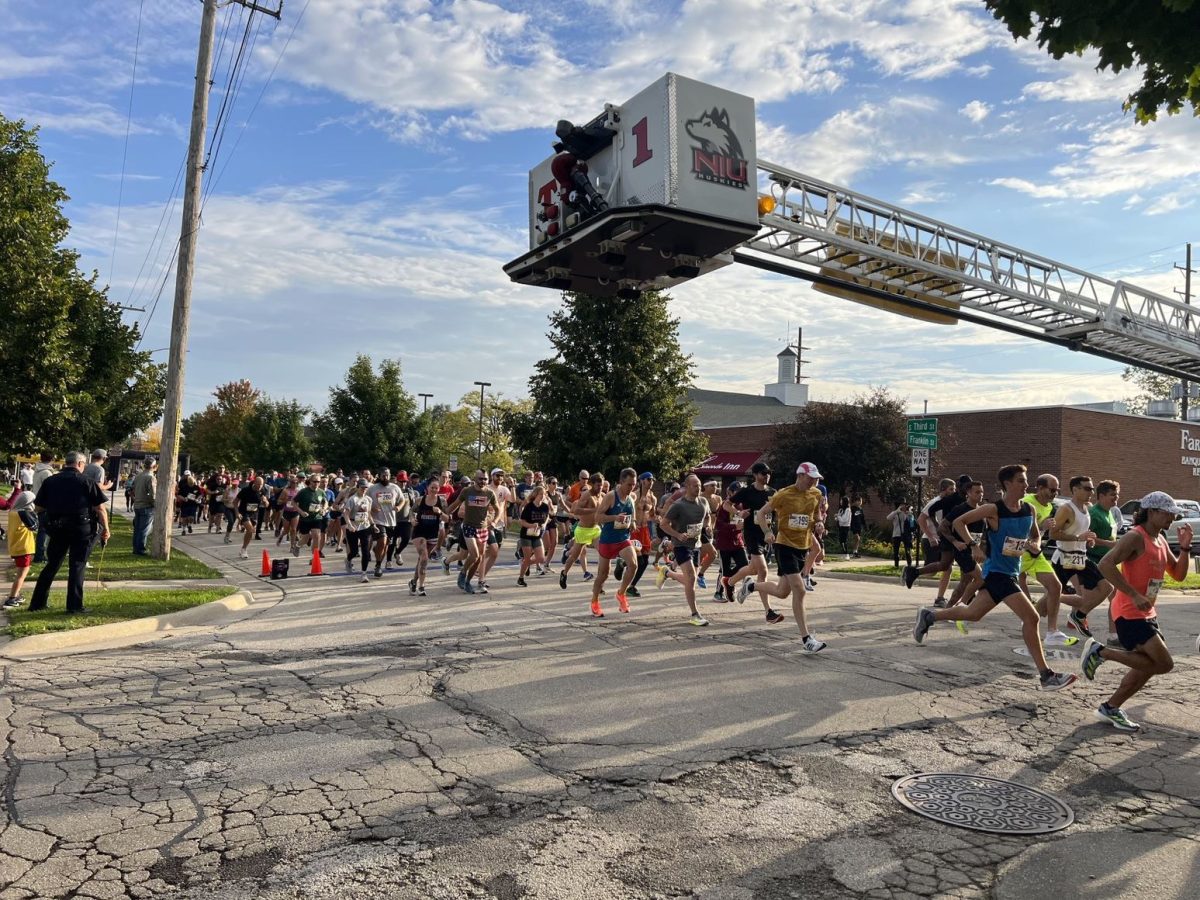 Participants of the Corn Classic 10K run Sunday down Third St. The Corn Classic starts and ends in downtown DeKalb taking runners through NIU’s Campus, and Van Buer Plaza with historical sites along the way. (Devin Oommen | Northern Star)