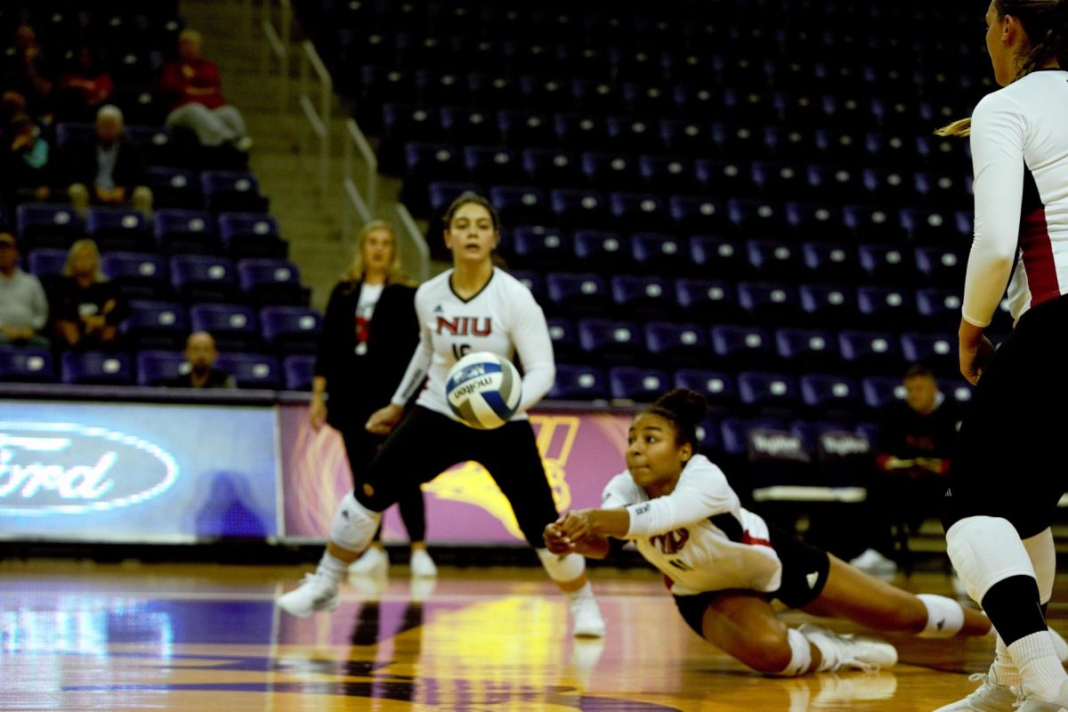 NIU junior middle blocker Charli Atiemo digs up a ball during Friday’s match between the NIU Huskies and the University of Dayton Flyers. The Huskies went on to fall in three sets to UNI Tournament host University of Northern Iowa on Saturday, ending the weekend with a 2-1 record in the tournament. (Logan Colglaizer | UNI Athletics)