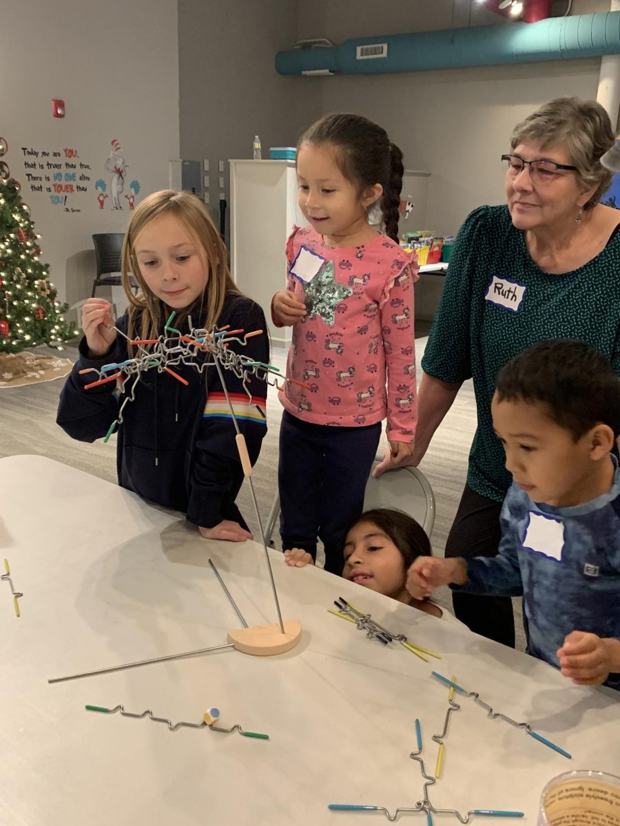 A group of children are playing with a tree-like toy. A 2022 Promise Grant to Neighbors’ House provided new board games and learning activities for after-school groups. (Courtesy of DeKalb County Community Foundation)