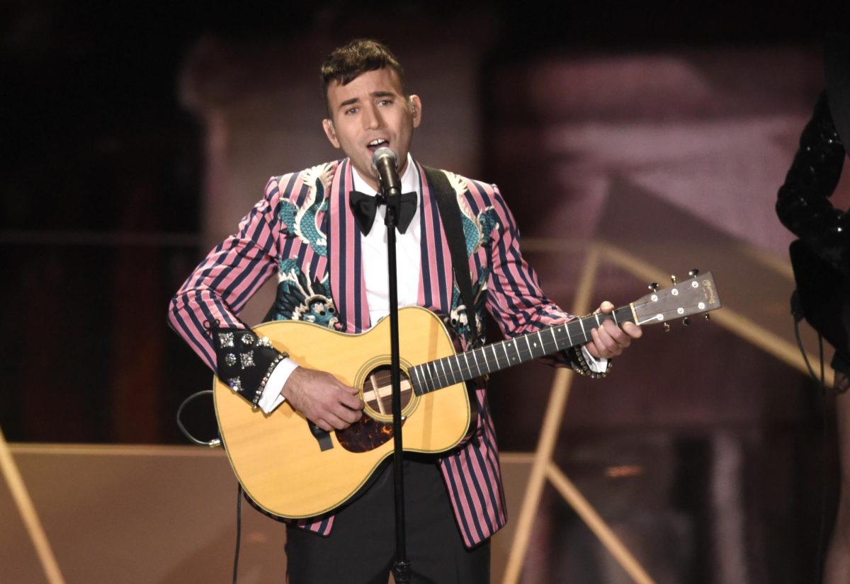 Sufjan Stevens performs his song Mystery of Love in a striped pink and black suit sequined with dragons. Stevens releases a new album toward the end of this year along with several other artists. (Chris Pizzello/Invision/AP)