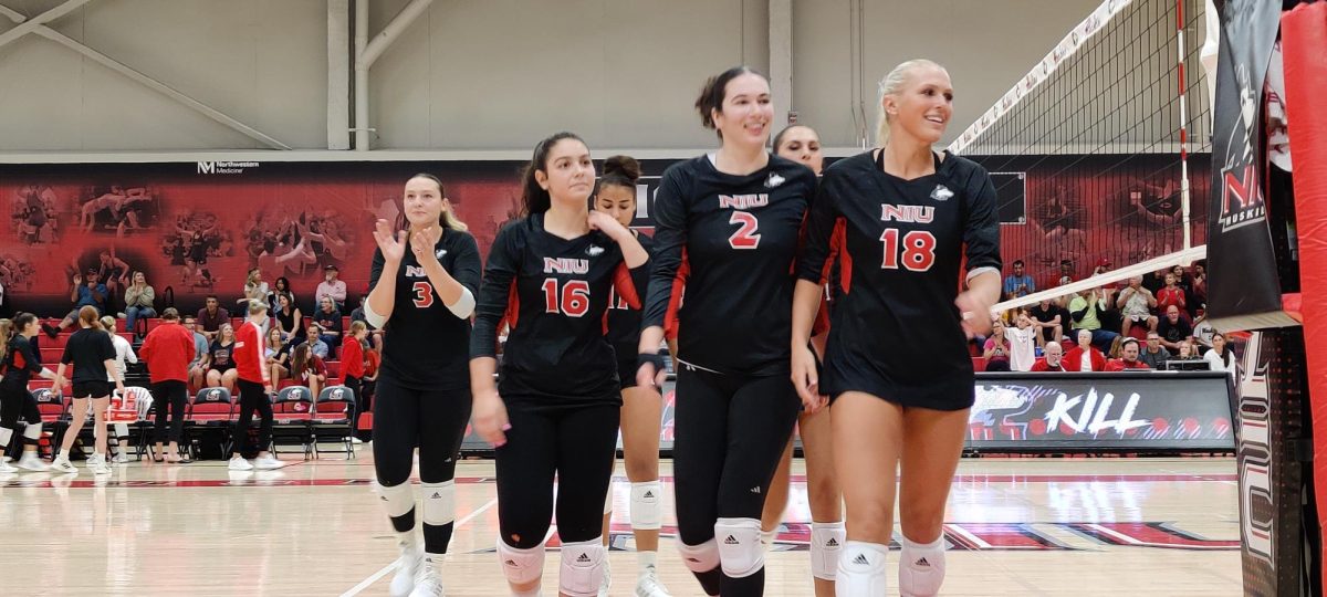 From left: Graduate outside hitter Katie Erdmann, junior setter Sophie Hurt, junior middle blocker Charli Atiemo, graduate student outside hitter Isabelle Percoco, junior outside hitter Nikolette Nedic and sophomore middle blocker Savanah Brandt switch sides after winning the second set of Saturdays volleyball match between NIU and Miami University at Victor E. Court. The Huskies defeated the RedHawks to complete a weekend sweep of Miami. (Josephine Dunmore | Northern Star) 