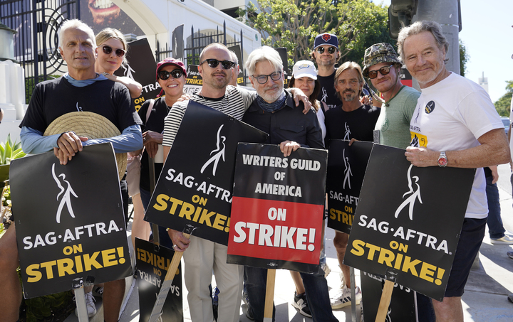 Cast and writers from Breaking Bad and Better Call Saul pose on a picket line on Aug. 29 outside Sony Pictures studios in Culver City, California. The film and television industries remain paralyzed by Hollywoods dual actors and screenwriters strikes. Pictured are Patrick Fabian (from left), Rhea Seehorn, Norma Maldonado, Aaron Paul, Peter Gould, Betsy Brandt, Matt Jones, Charles Baker, Jesse Plemons and Bryan Cranston. (AP Photo/Chris Pizzello)