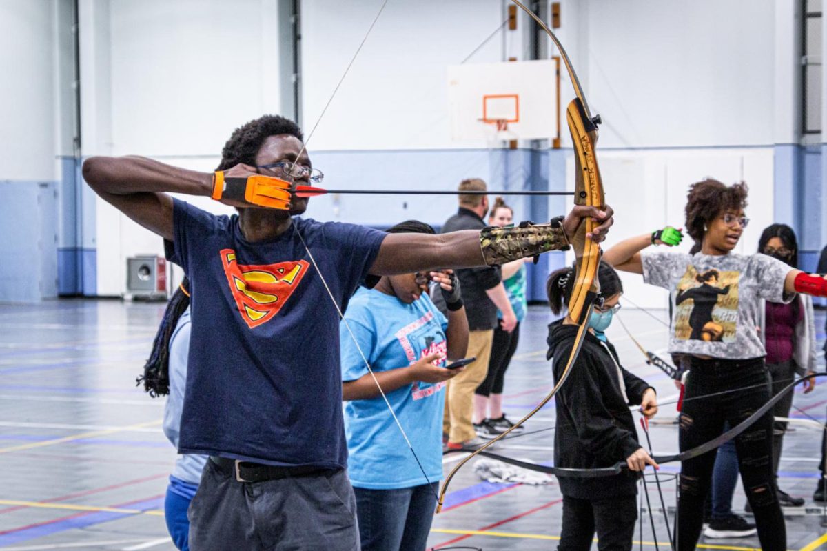 Club Secretary Janek Sunga, a political science Ph.D. student, shoots an arrow during the meeting in Anderson Hall, Room 100. NIU Archery Club provides a chance for students to participate in an individual sport. (Mingda Wu | Northern Star)