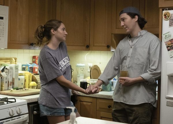 Shailene Woodley (left) and Paul Dano interacting in a scene from the film Dumb Money. The movie is out in theaters and tells the story about how GameStop turned into a popular business because of normal Reddit users. (Claire Folger/Sony Pictures via AP)