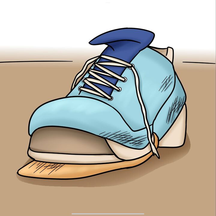 A tattered and worn shoe sits on the ground. Fast fashion is produced quick and cheap, and it is not meant to last. (Robin Gamboa | Northern Star)