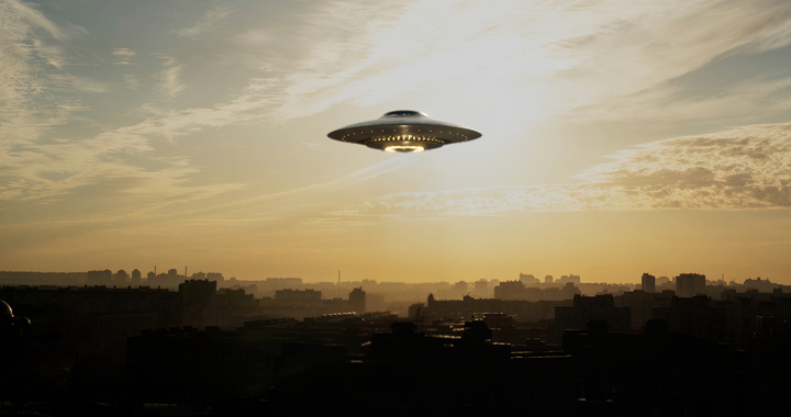 An Illustration of an UFO saucer hovers over a city. A retired Air Force intelligence officer has recently testified in court regarding the retrieval and reverse engineering of wrecked UFOs. (Getty Images)