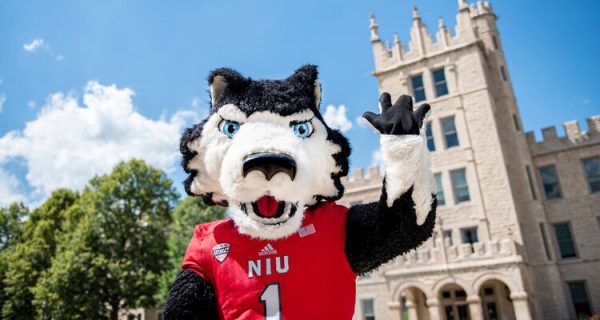 Victor E. Huskie waves at the camera in front of Altgeld Hall. The upcoming 116th Homecoming at NIU will be a great opportunity to exhibit Huskie pride. (Courtesy of Northern Illinois University)