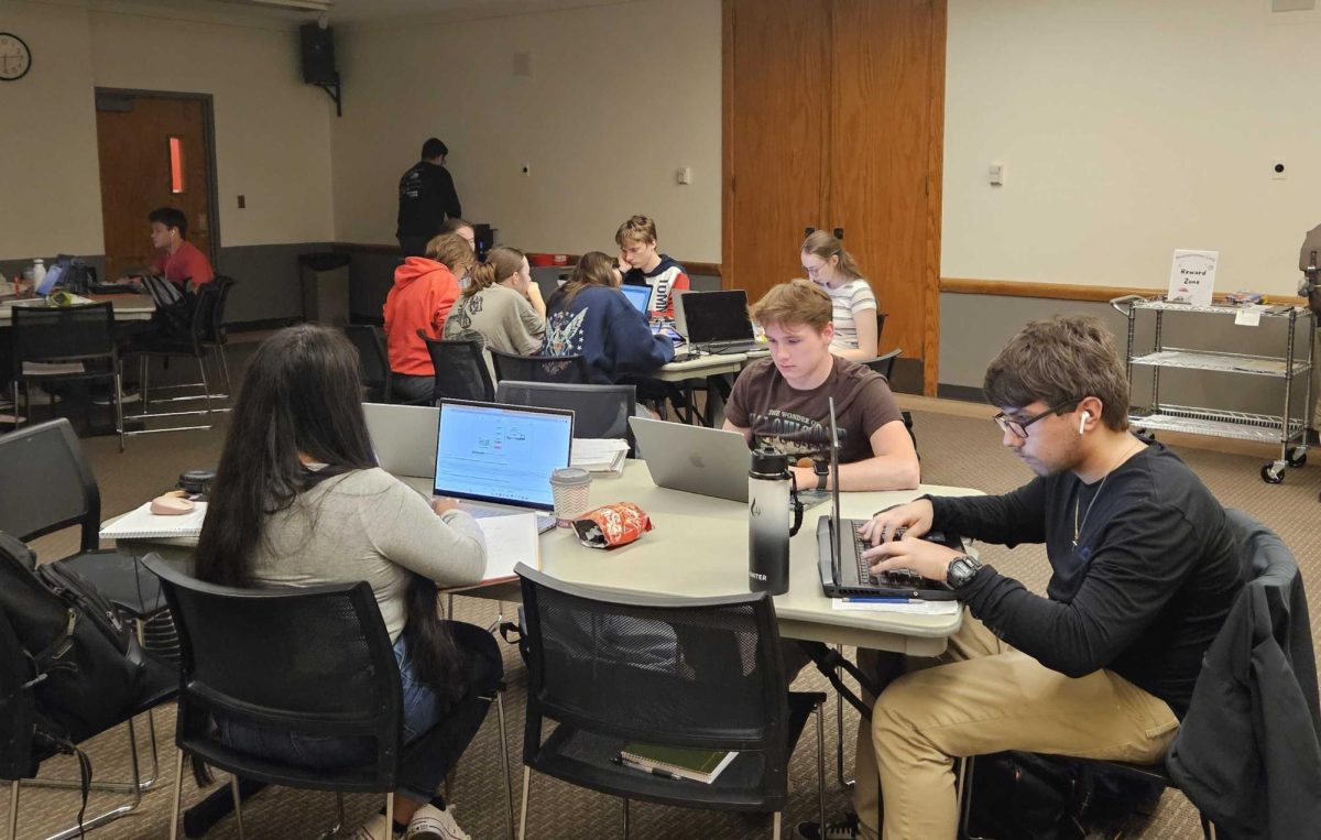 Students focus on school assignments at the Procrastination Café Holmes Student Center’s Illinois Room. The Procrastination Café is open to students and NIU staff between 5 p.m. to 8 p.m. every Tuesday. (Joseph Howerton | Northern Star)