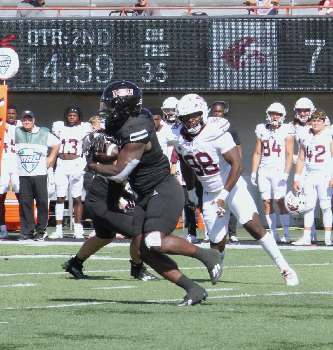 Junior running back Antario Brown (1), takes possession of the ball during the second quarter of the Huskies game against Southern Illinois University on Sept. 9. (Nyla Owens | Northern Star)