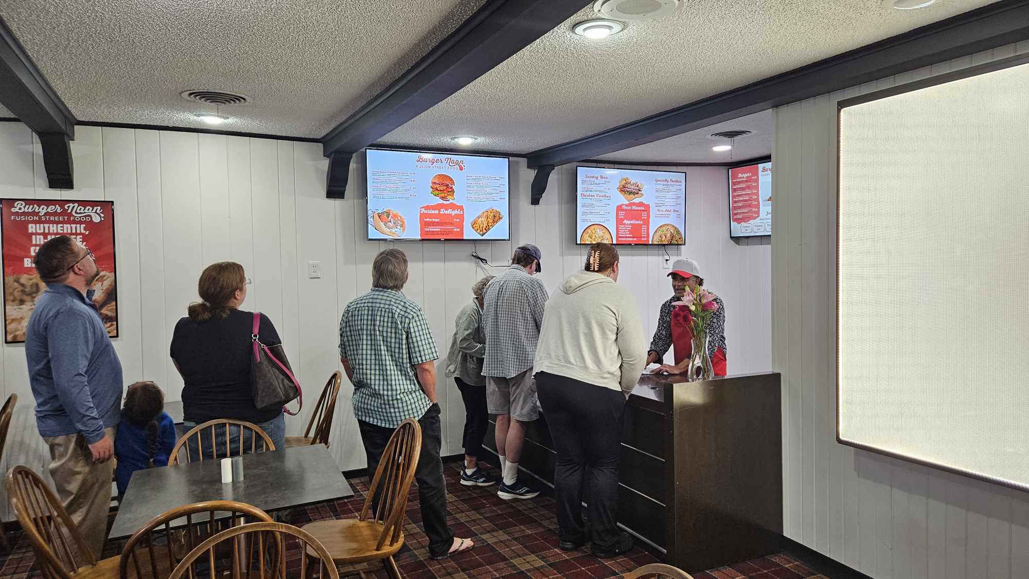 Customers wait in line to order at Burger Naan. Burger Naan is a new fusion street food restaurant in DeKalb. (Joeseph Howerton | Northern Star)