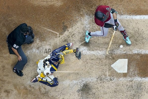 Arizona Diamondbacks Evan Longoria hits a single during the sixth inning of a Game 1 of their National League wildcard baseball series against the Milwaukee Brewers Tuesday, Oct. 3, 2023, in Milwaukee. (AP Photo/Morry Gash)