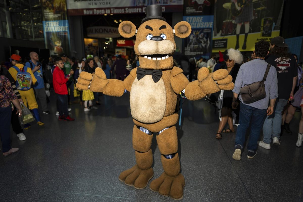 A person dresses as Freddy Fazbear from the game Five Nights at Freddys during New York Comic Con. The games movie adaptation of the same name releases in theaters Oct. 27. (Photo by Charles Sykes/Invision/AP)