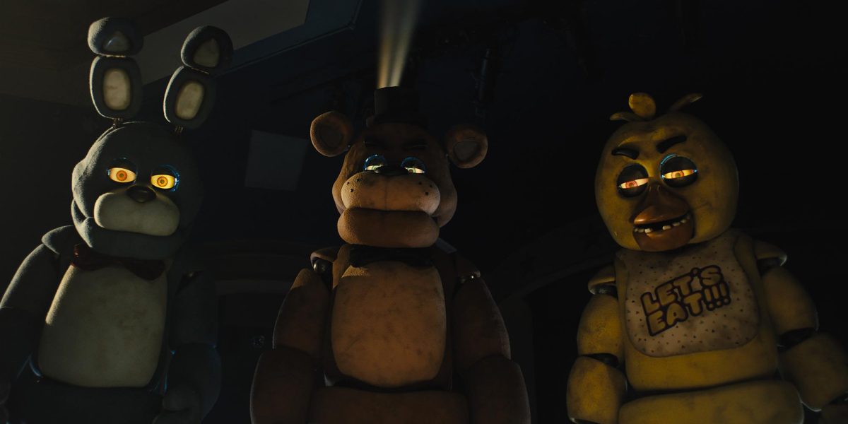 From left: Bonnie, Freddy Fazbear and Chica stand side by side, staring downward in a scene from Five Nights at Freddys. The film recently made its theatrical release after being in the works for eight years. (Universal Pictures via AP)